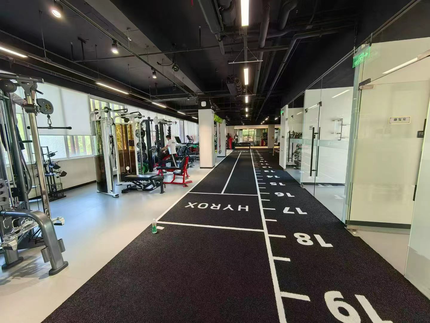 Artificial turf sled track in a commercial gym